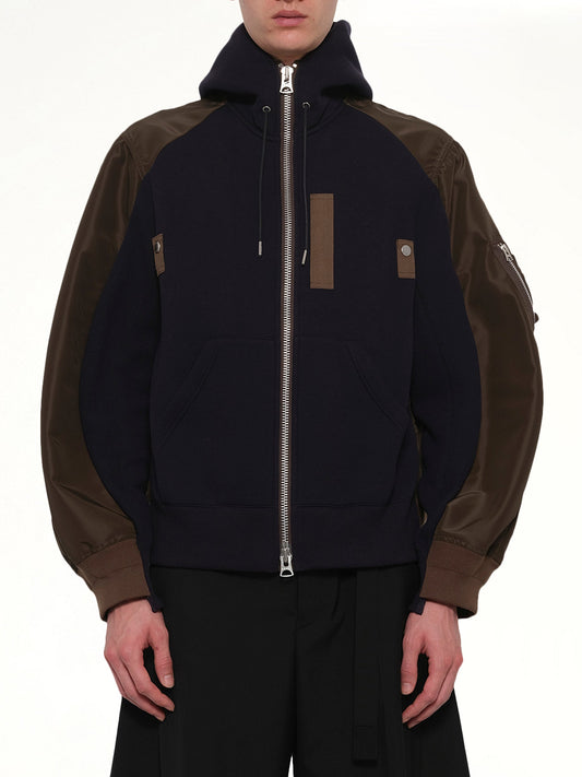 Image of a model wearing Outerwear. Product name - Sponge Sweat Hoodie in Navy colour by brand - SACAI