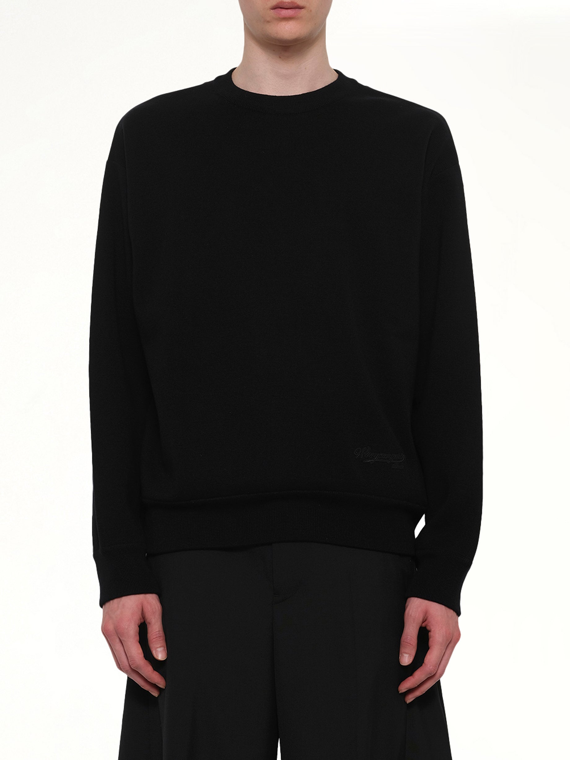 Image of a model wearing Outerwear. Product name - Baseball Logo Sweater in Black colour by brand - WOOYOUNGMI