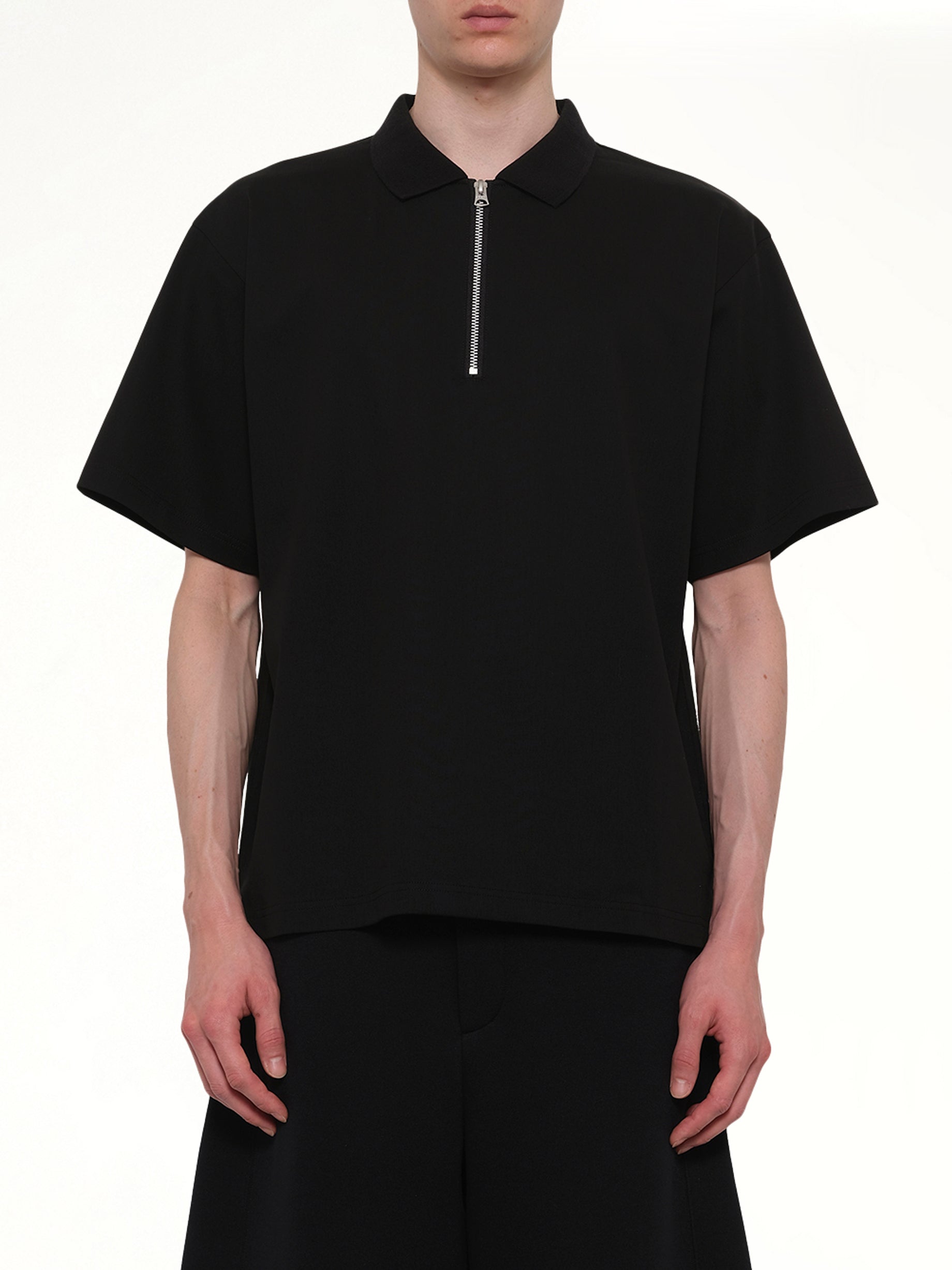 Image of a model wearing Tops. Product name - Cotton Jersey Polo in Black colour by brand - SACAI