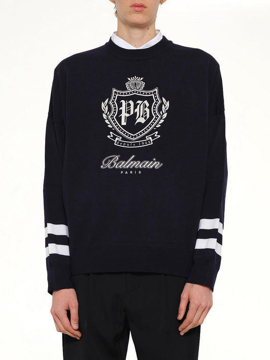 Image of a model wearing Outerwear. Product name - College Emblem Boxy Sweater in Marine/Natural colour by brand - BALMAIN