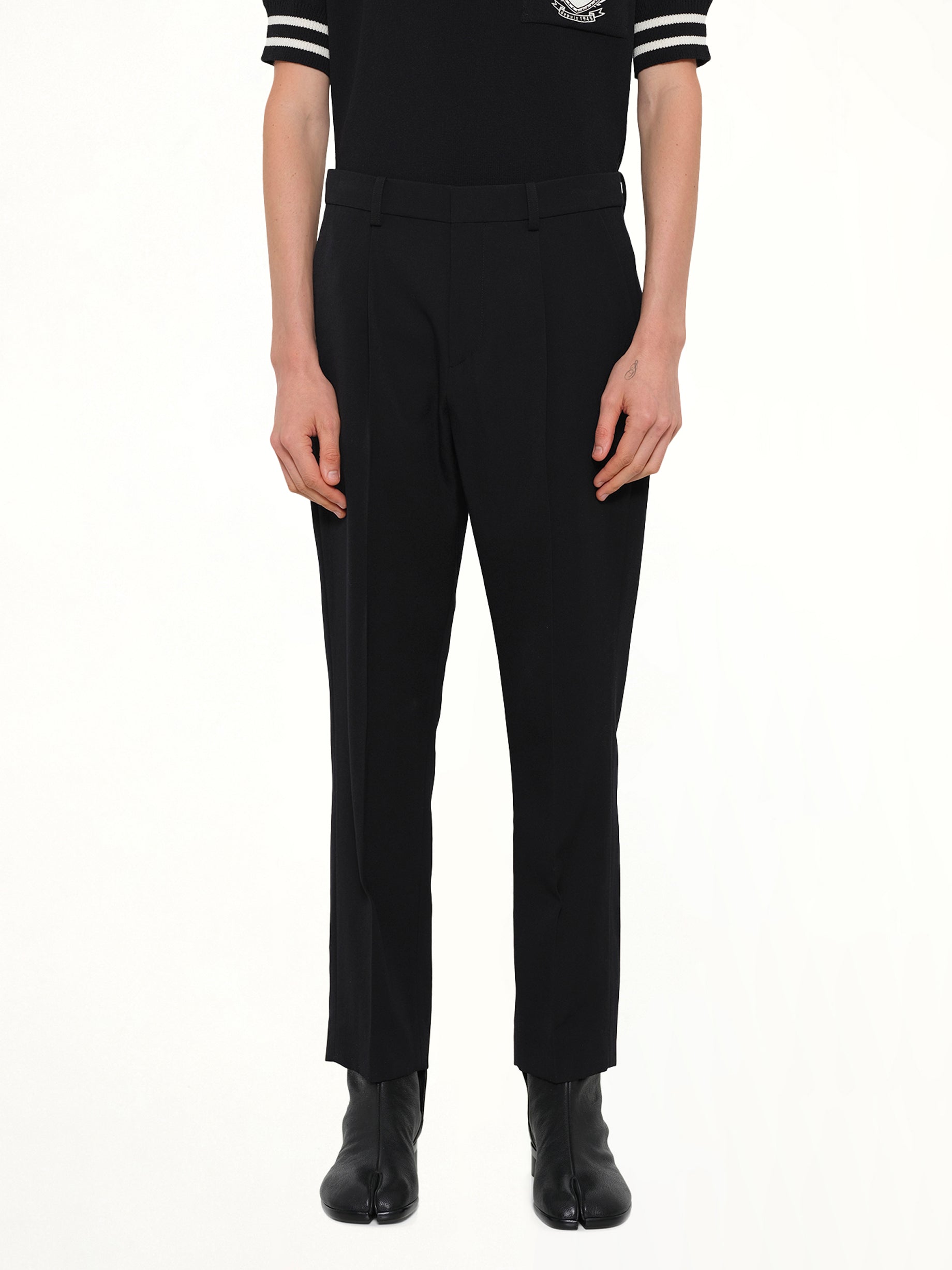 Image of a model wearing Pants. Product name - Straight GDP Pants in Black colour by brand - BALMAIN