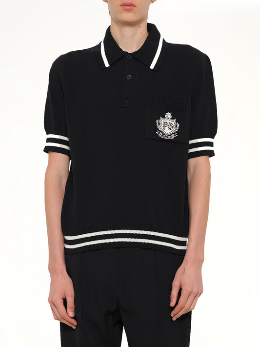 Image of a model wearing Tops. Product name - College Emblem Knit Polo in Black colour by brand - BALMAIN