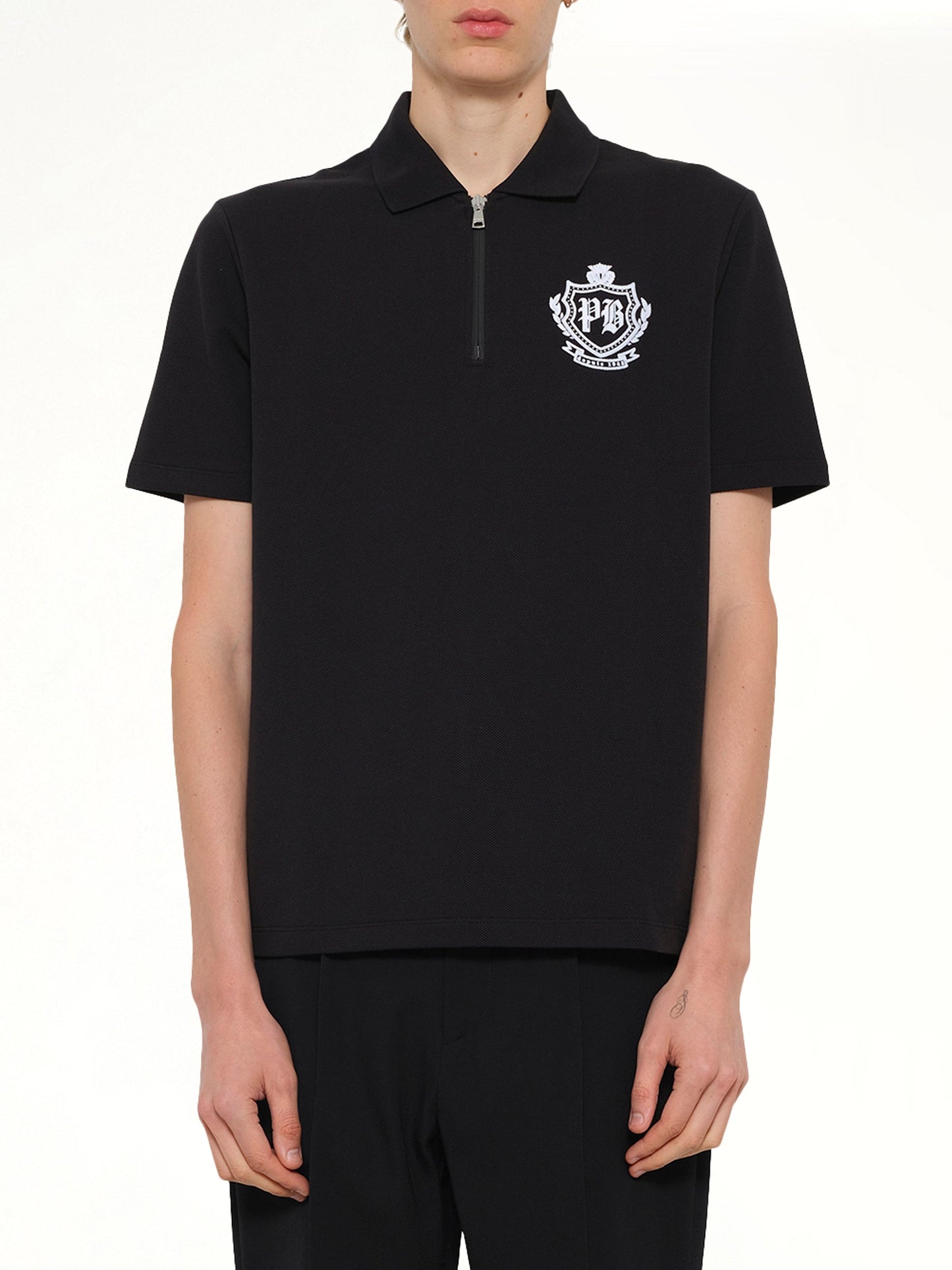 Image of a model wearing Tops. Product name - College Emblem Polo in Black colour by brand - BALMAIN