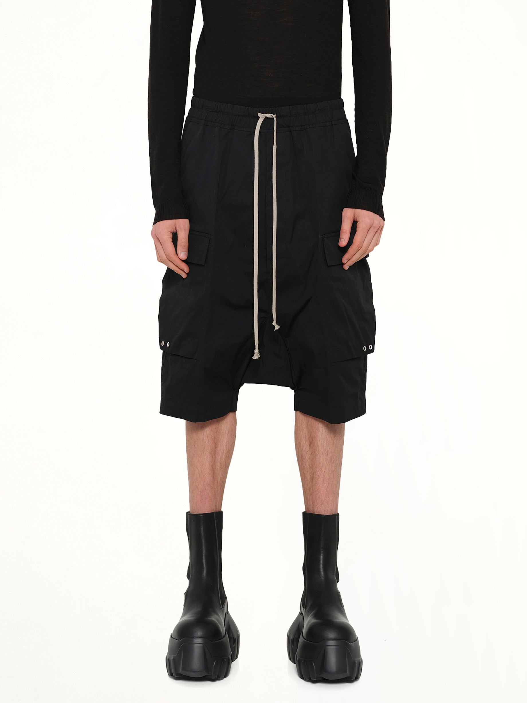 Image of a model wearing Shorts. Product name - Cargo Pods in Black colour by brand - RICK OWENS
