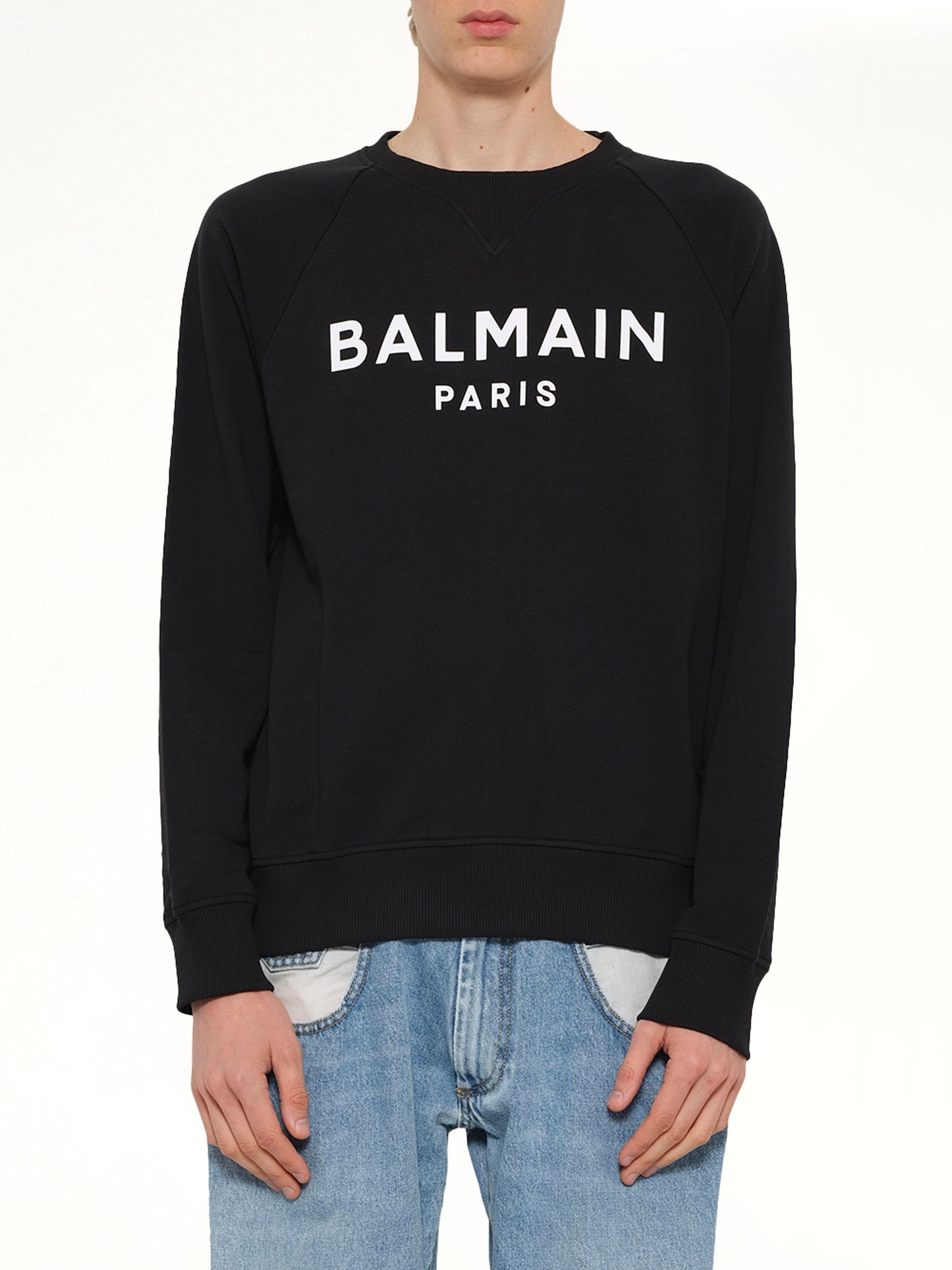 Image of a model wearing Outerwear. Product name - Balmain Print Sweatshirt in Black colour by brand - BALMAIN