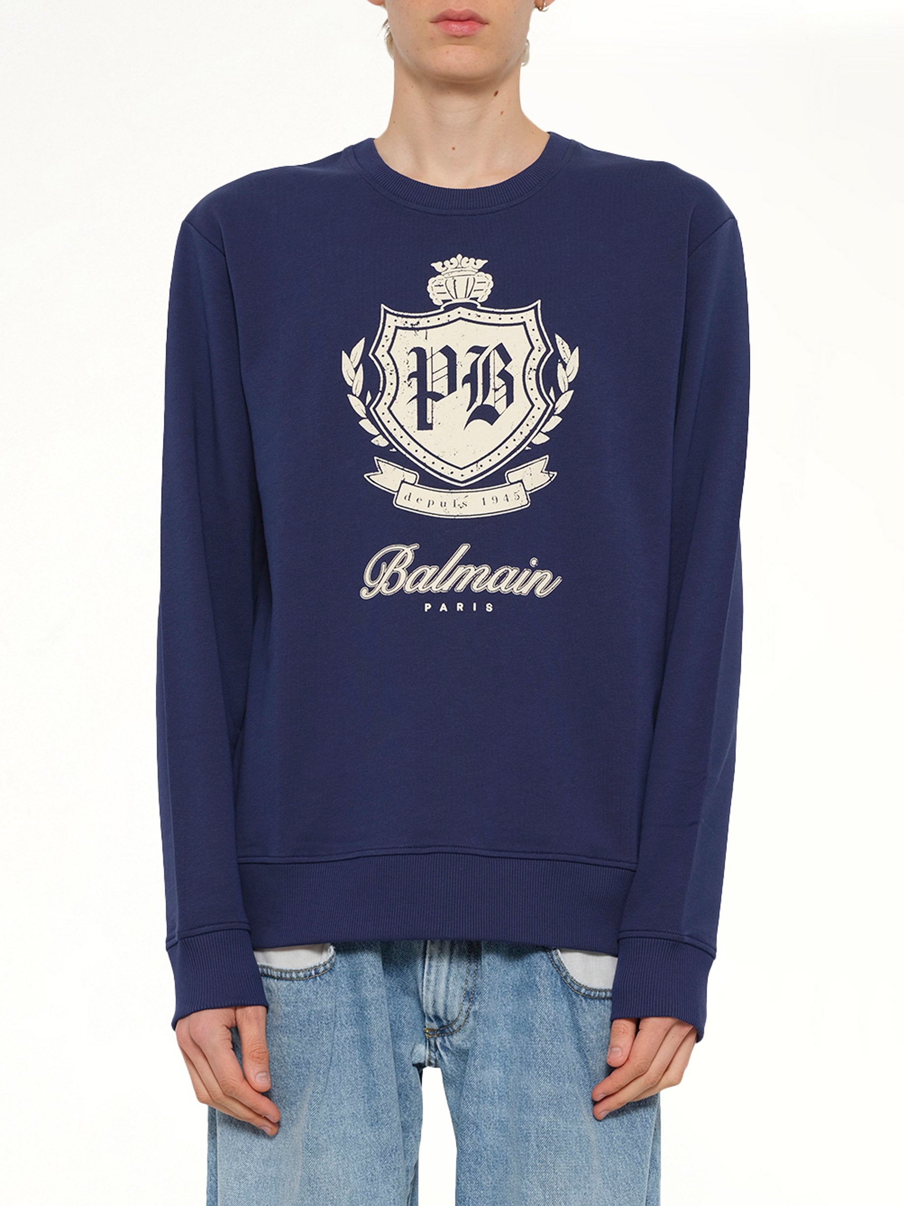 Image of a model wearing Outerwear. Product name - College Emblem Sweatshirt in Blue colour by brand - BALMAIN