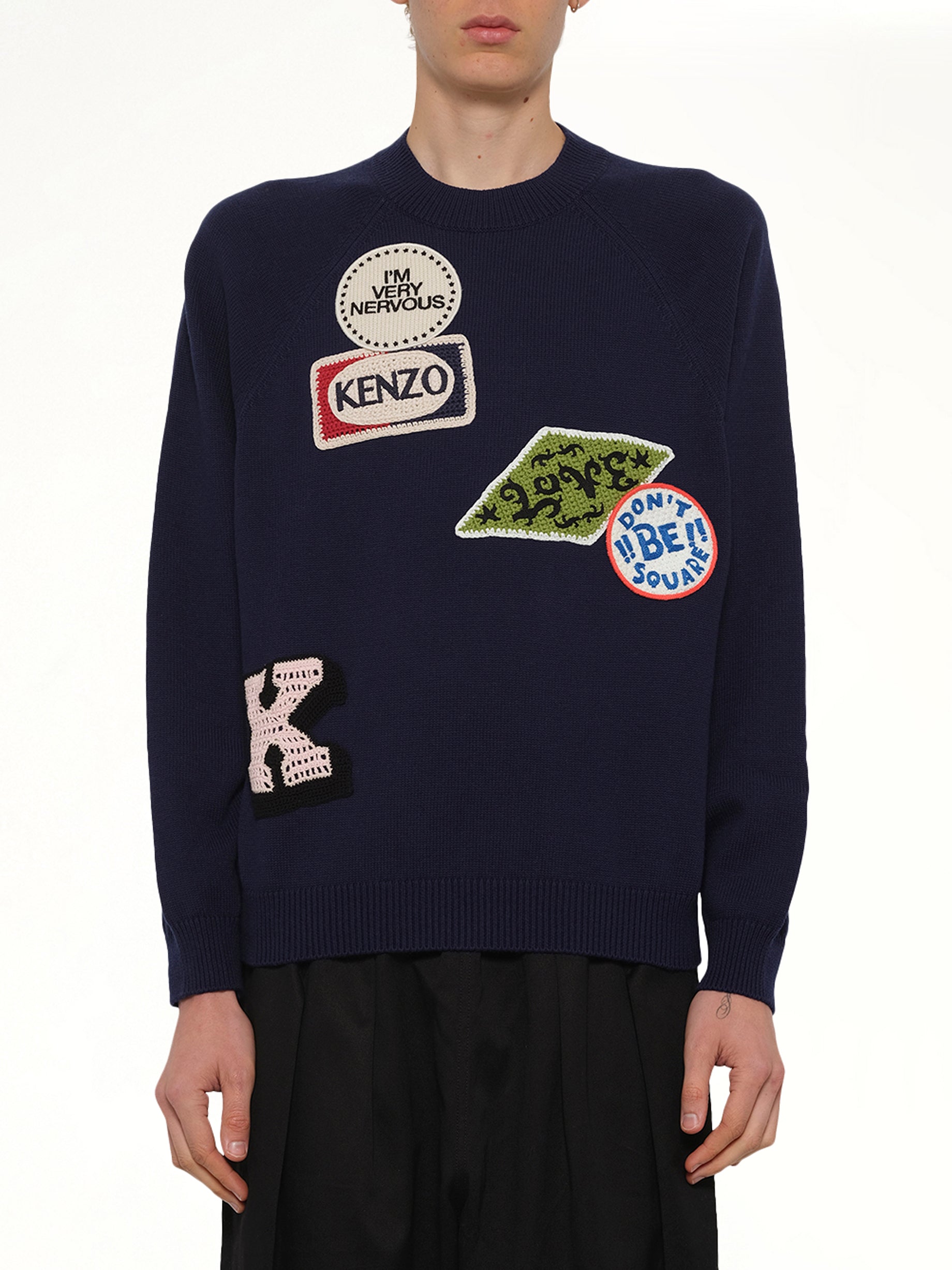 Image of a model wearing Outerwear. Product name - Kenzo Badges Jumper in Navy colour by brand - KENZO