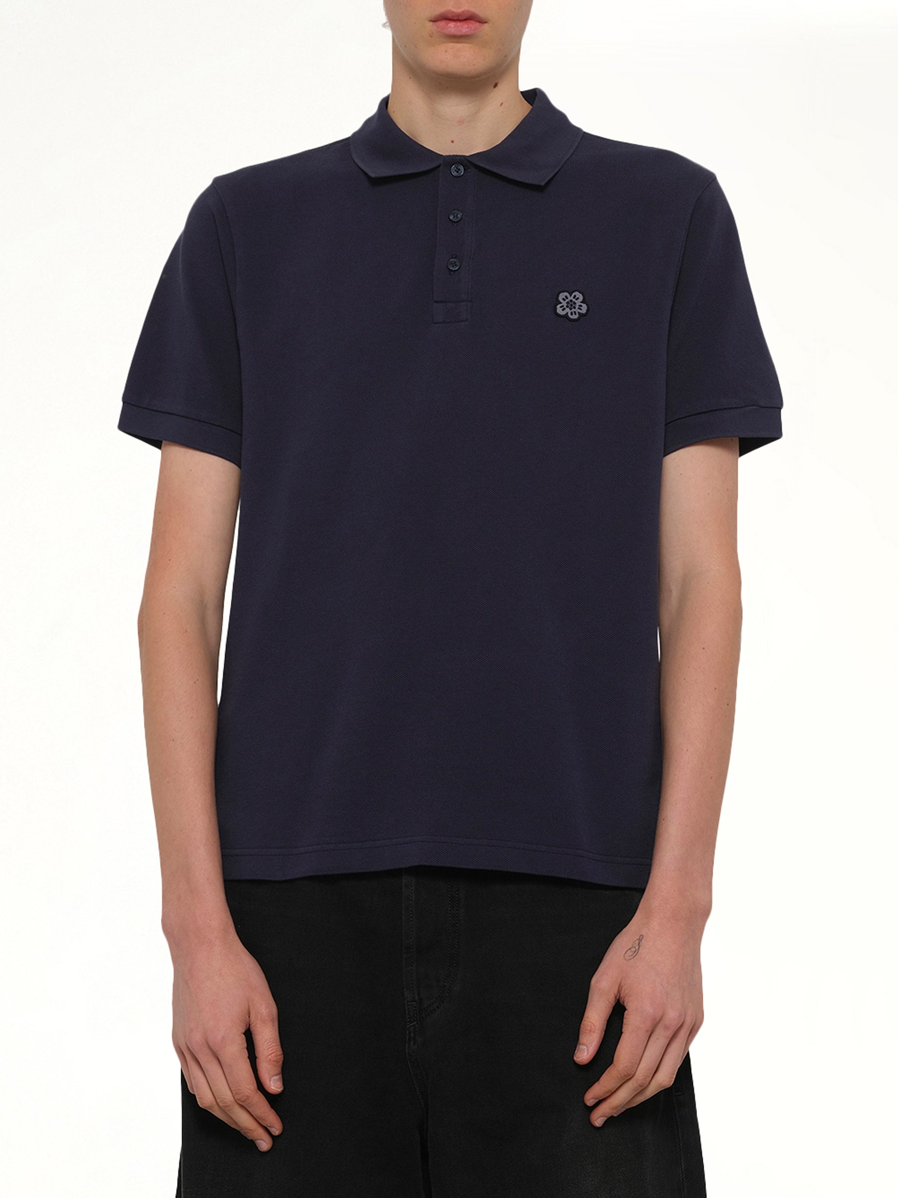 Image of a model wearing Tops. Product name - Gots Boke Flower Embroidered Slim Polo in Navy colour by brand - KENZO