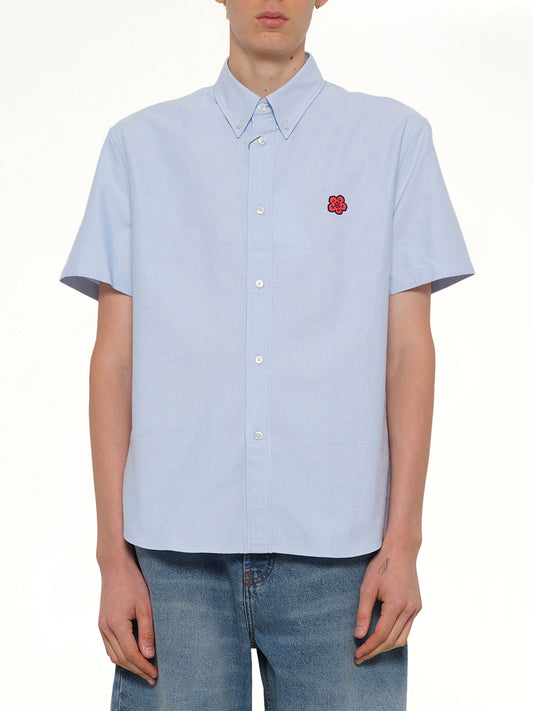 Image of a model wearing Tops. Product name - Boke Flower Crest Short Sleeve Shirt in Blue colour by brand - KENZO
