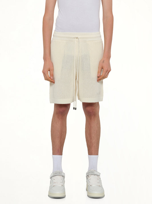 Image of a model wearing Shorts. Product name - Amiri Crochet Mesh Short in Ivory colour by brand - AMIRI