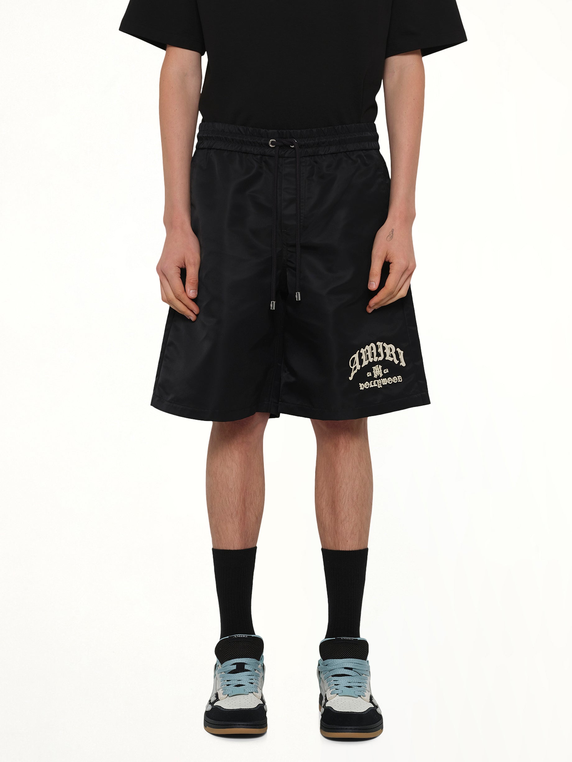 Image of a model wearing Shorts. Product name - Amiri Hollywood Short in Black colour by brand - AMIRI