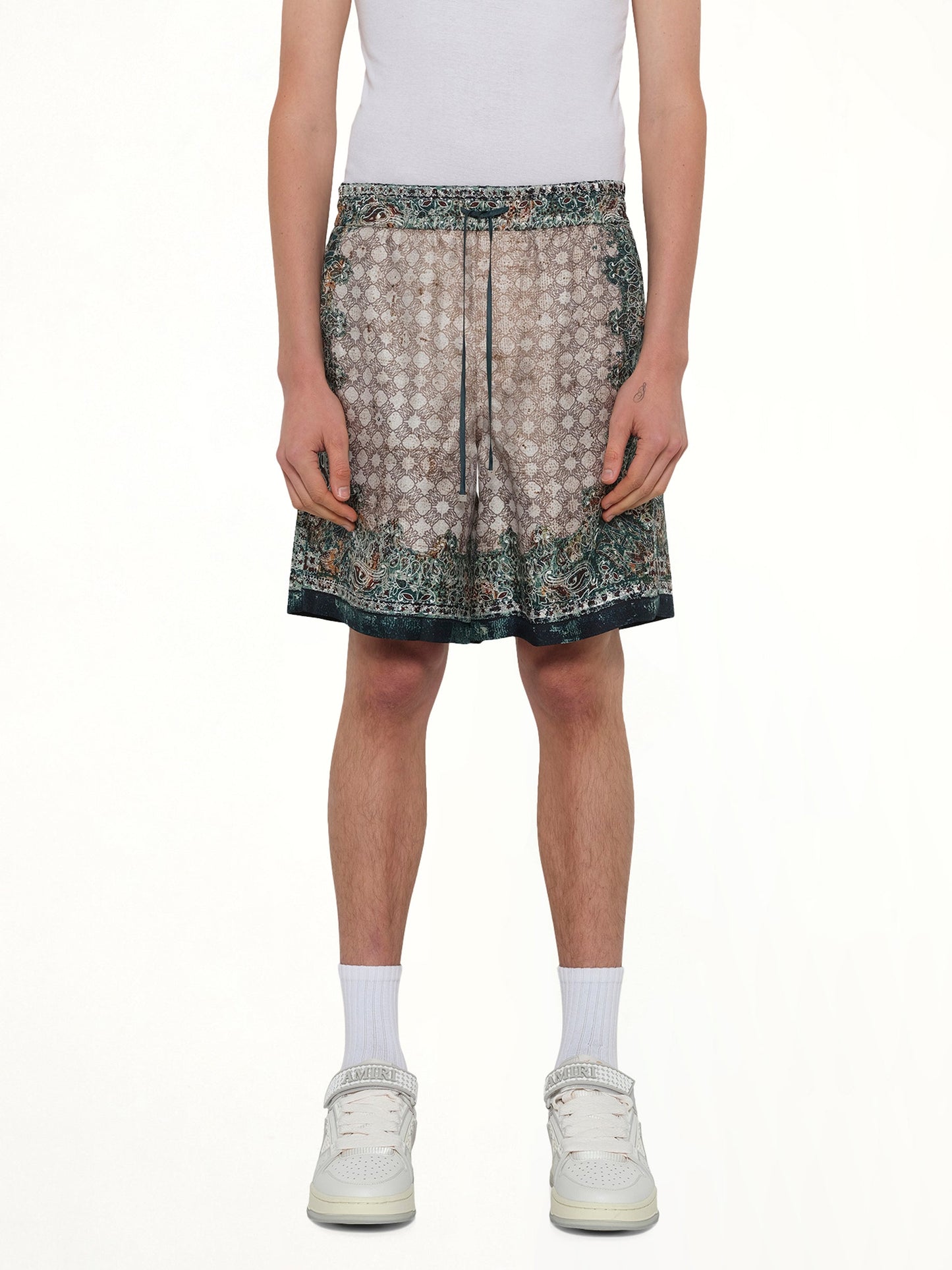 Image of a model wearing Shorts. Product name - Bandana Shorts in Green colour by brand - AMIRI