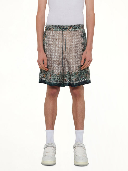 Image of a model wearing Shorts. Product name - Bandana Shorts in Green colour by brand - AMIRI