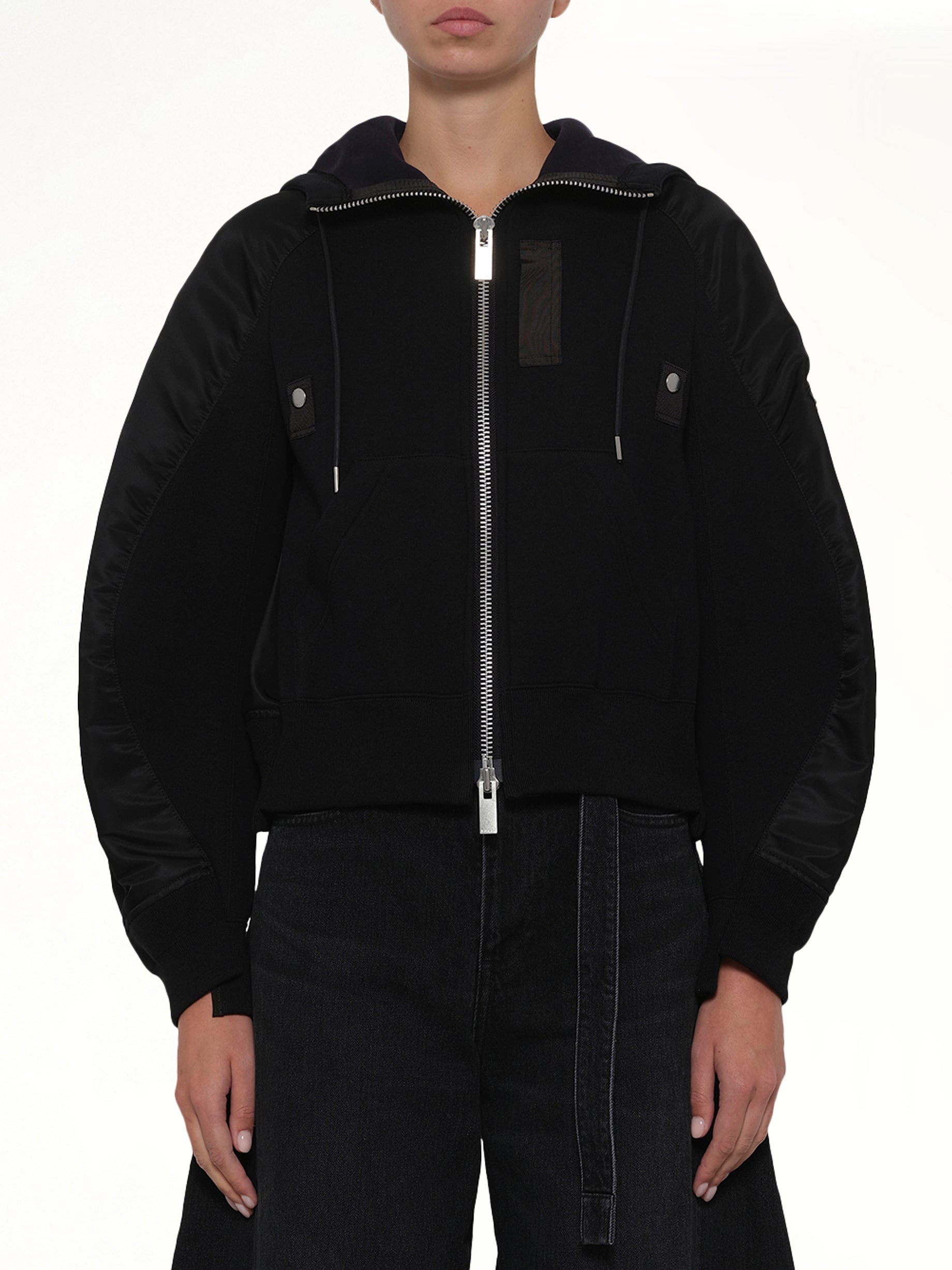 Image of a model wearing Outerwear. Product name - Sponge Sweat Twist Hoodie in Black colour by brand - SACAI