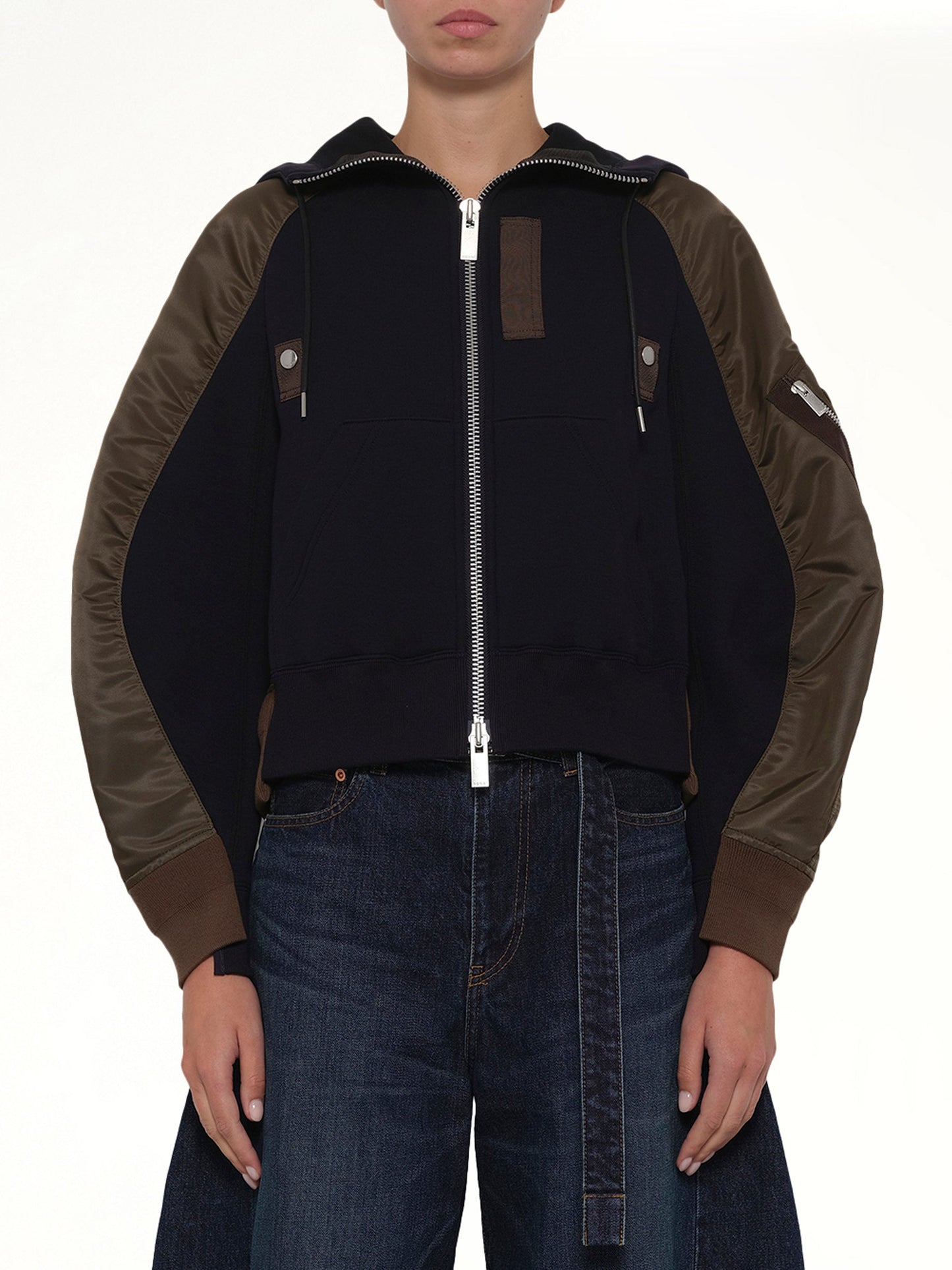 Image of a model wearing Outerwear. Product name - Sponge Sweat Twist Hoodie in Navy colour by brand - SACAI