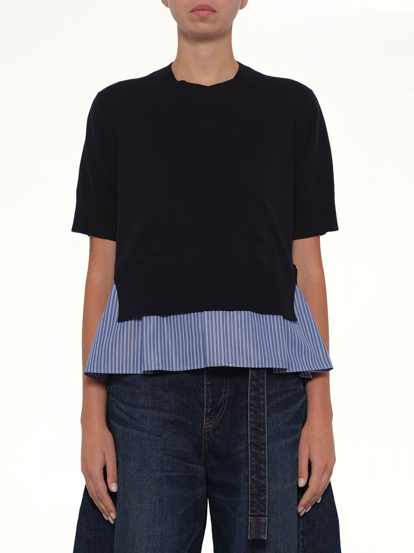 Image of a model wearing Outerwear. Product name - Poplin x Cotton Knit Pullover in Navy colour by brand - SACAI