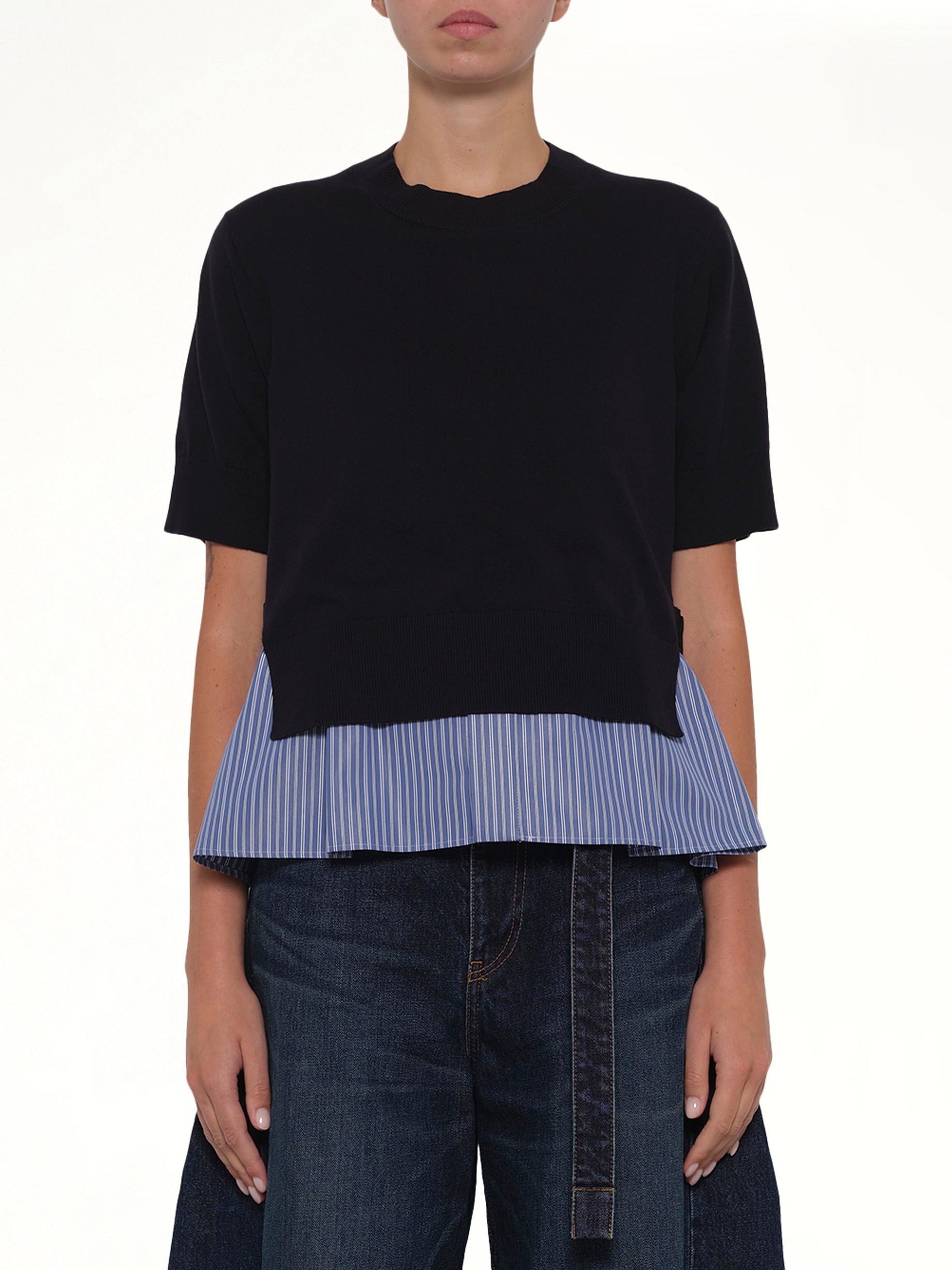 Image of a model wearing Outerwear. Product name - Poplin x Cotton Knit Pullover in Navy colour by brand - SACAI
