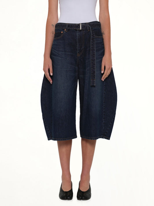 Image of a model wearing Shorts. Product name - Barrel Denim Bermuda Pants in Blue colour by brand - SACAI