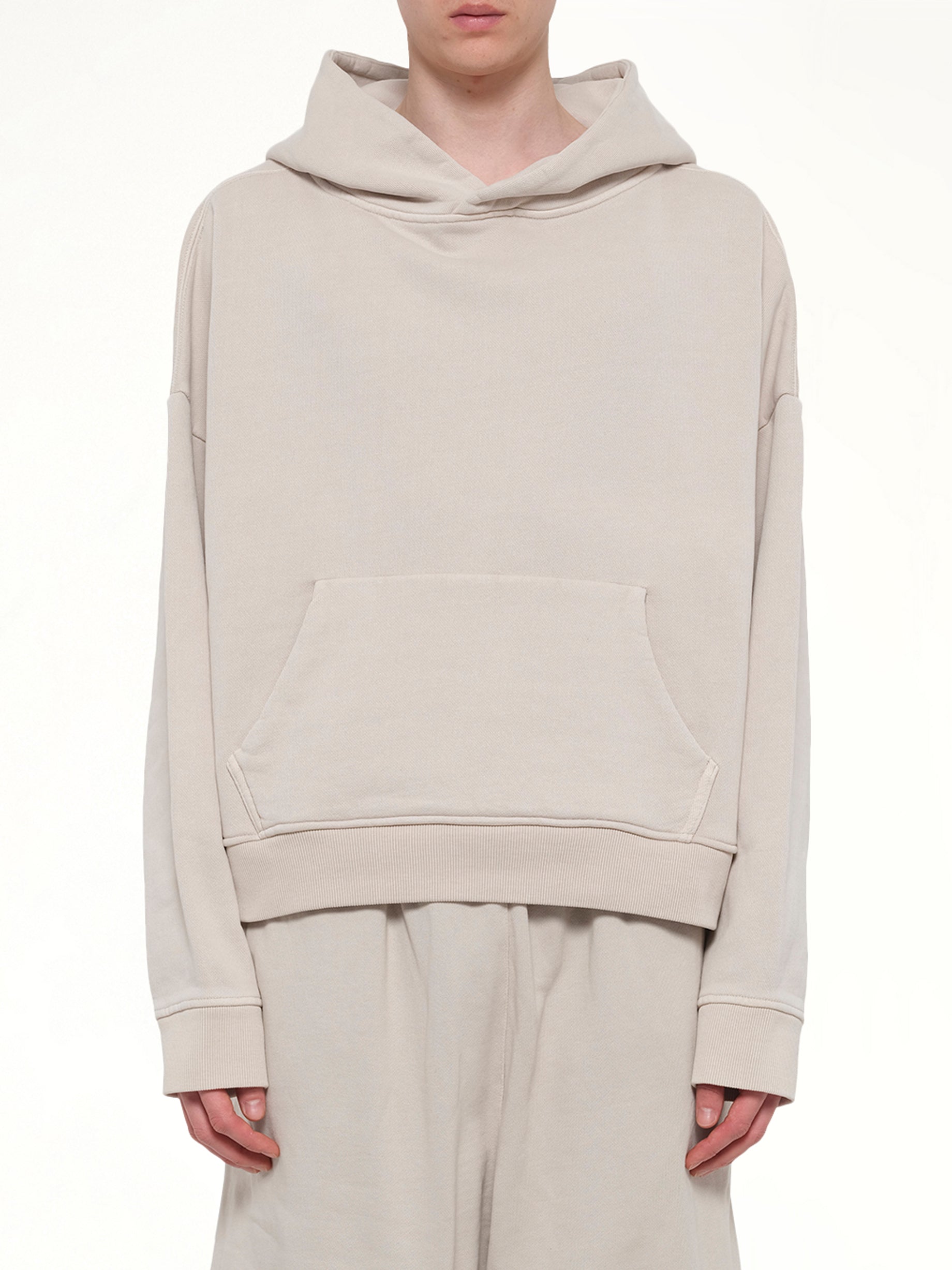 Image of a model wearing Outerwear. Product name - Heavy Hood in White colour by brand - ENTIRE STUDIOS