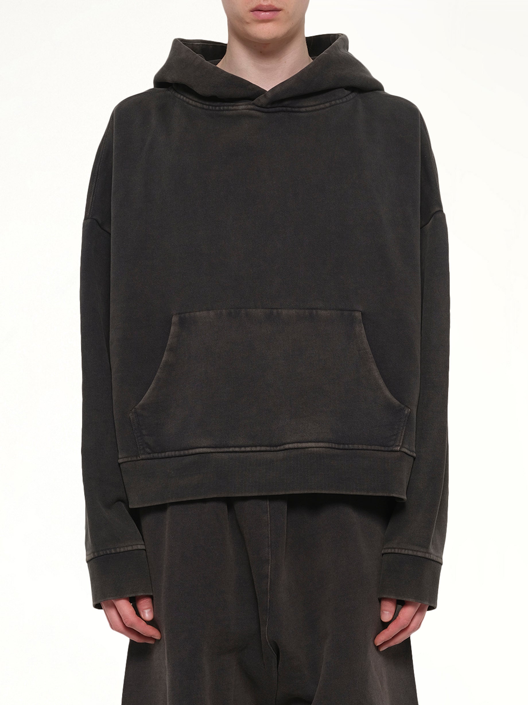 Image of a model wearing Outerwear. Product name - Heavy Hood in Black colour by brand - ENTIRE STUDIOS