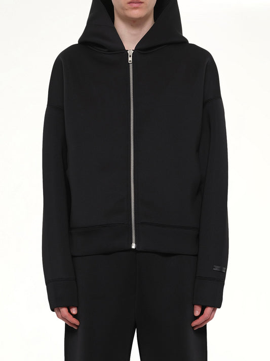 Image of a model wearing Outerwear. Product name - Scuba Zip Hood in Black colour by brand - ENTIRE STUDIOS