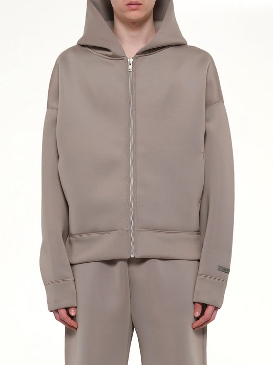 Image of a model wearing Outerwear. Product name - Scuba Zip Hood in Brown colour by brand - ENTIRE STUDIOS