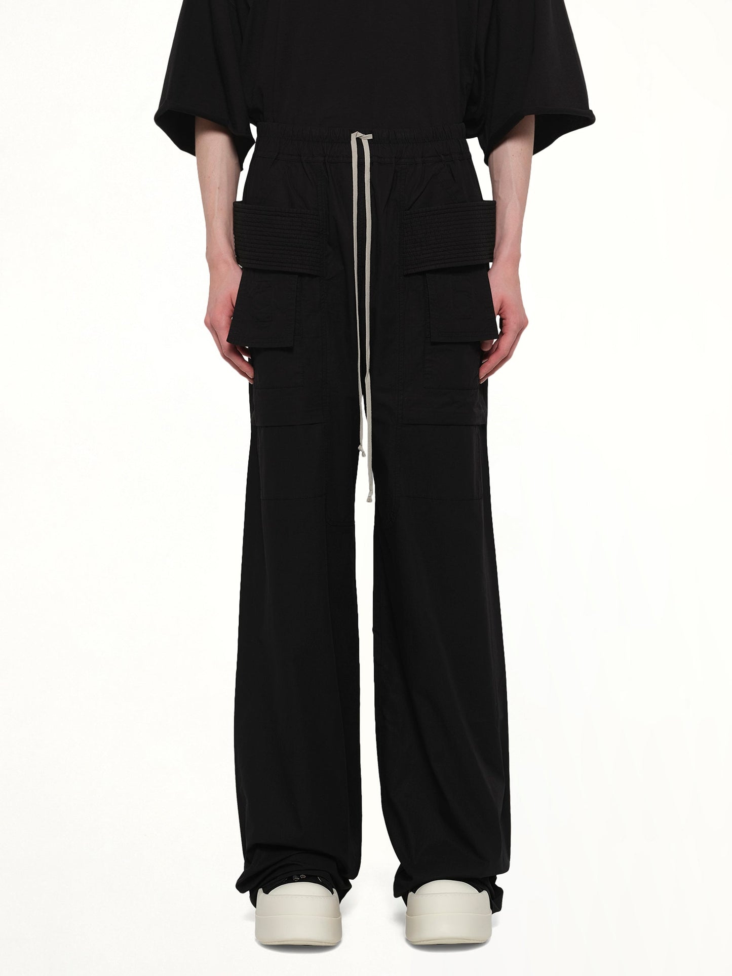 Image of a model wearing Pants. Product name - Creatch Wide Cargo Drawstring in Black colour by brand - RICK OWENS DRKSHDW