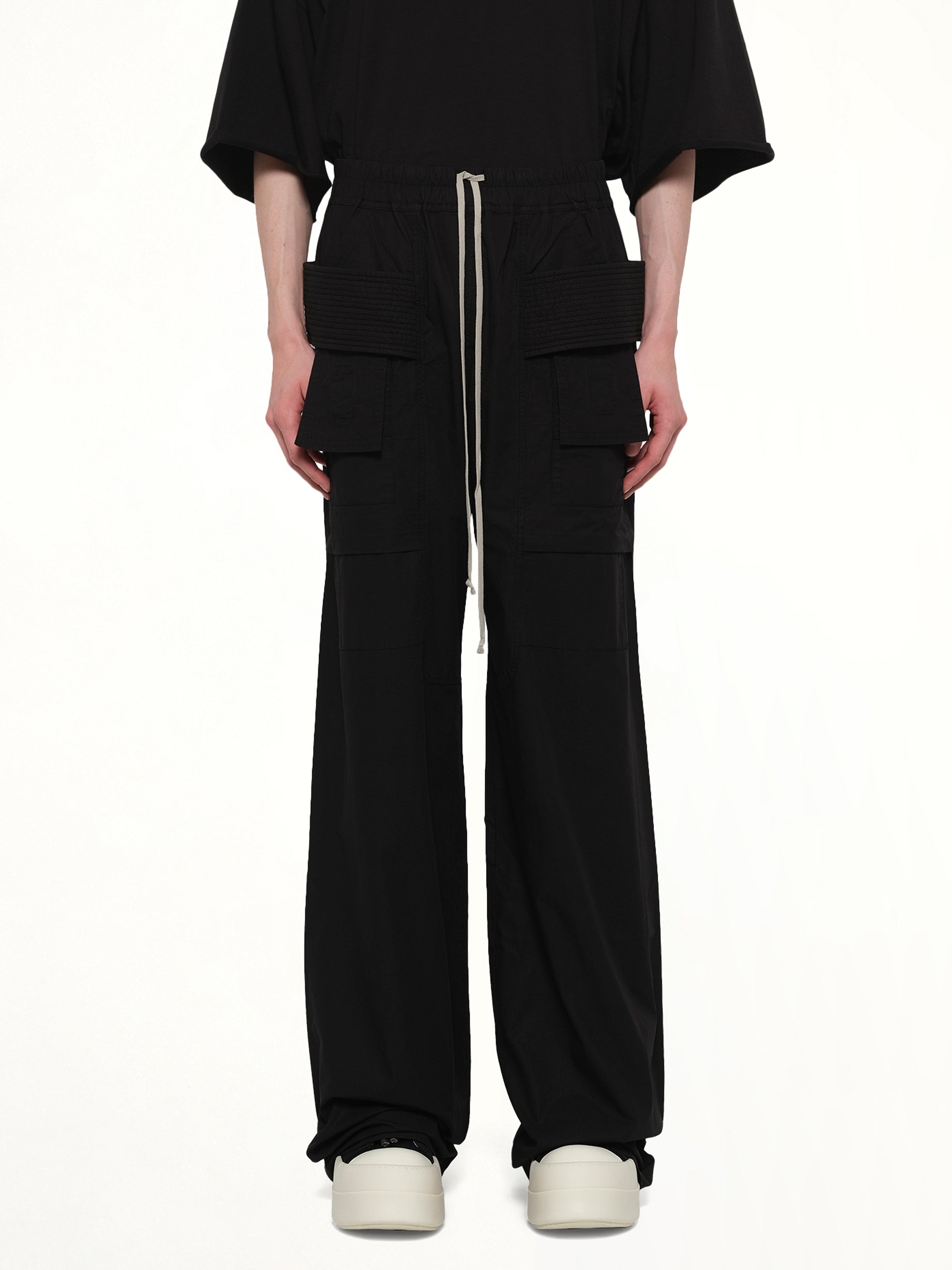 Image of a model wearing Pants. Product name - Creatch Wide Cargo Drawstring in Black colour by brand - RICK OWENS DRKSHDW