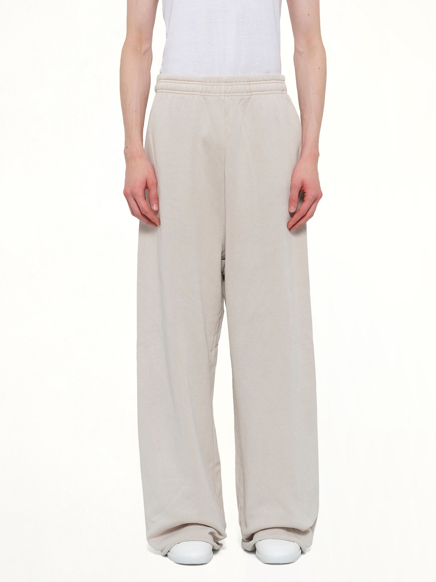 Image of a model wearing Pants. Product name - Full Sweatpant in White colour by brand - ENTIRE STUDIOS