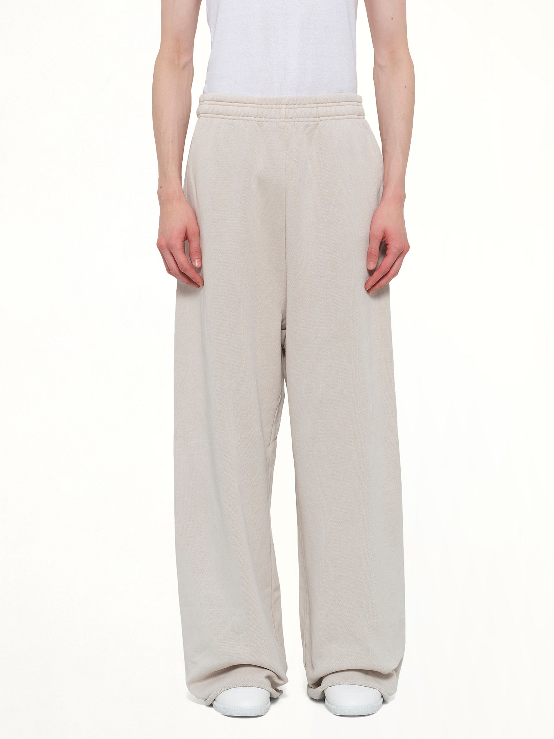 Image of a model wearing Pants. Product name - Full Sweatpant in White colour by brand - ENTIRE STUDIOS