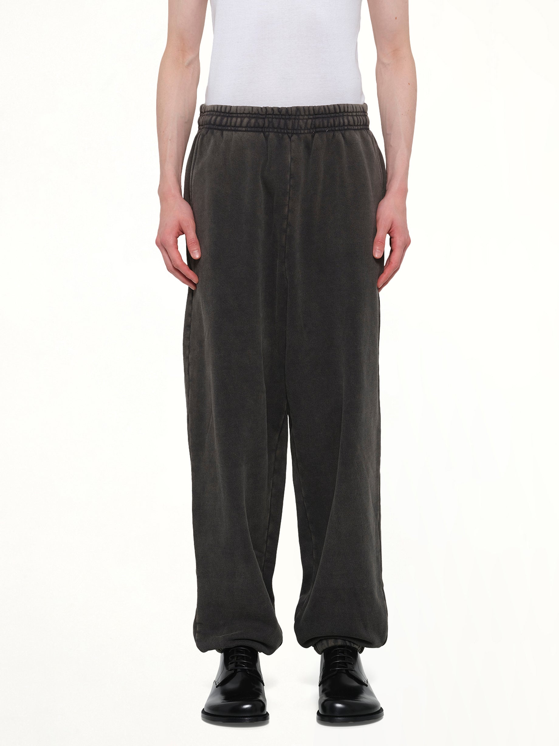Image of a model wearing Pants. Product name - Standard Sweatpants in Black colour by brand - ENTIRE STUDIOS
