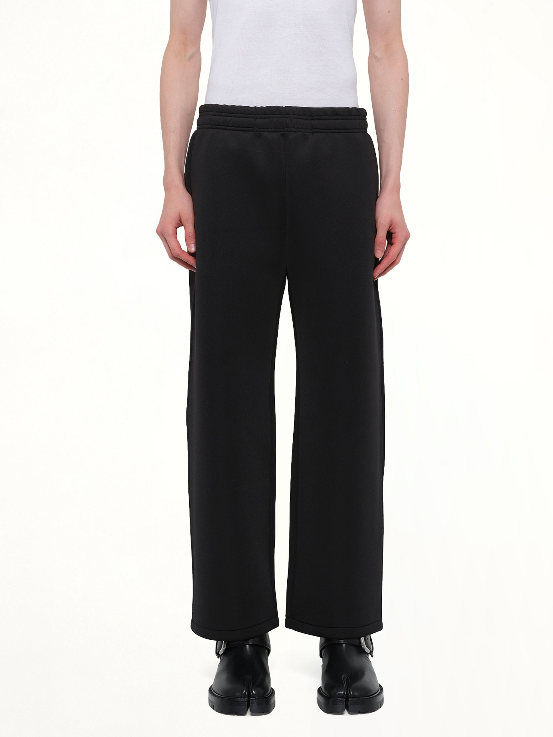 Image of a model wearing Pants. Product name - Straight Leg Scuba Sweatpants in Black colour by brand - ENTIRE STUDIOS