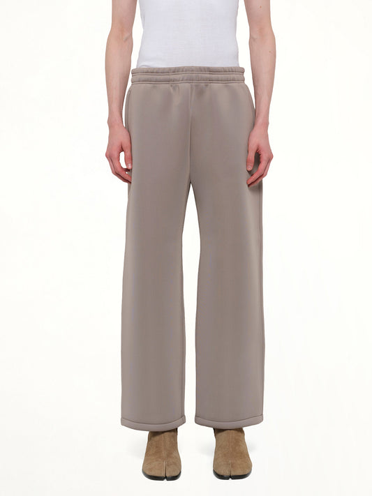 Image of a model wearing Pants. Product name - Straight Leg Scuba Sweatpants in Brown colour by brand - ENTIRE STUDIOS