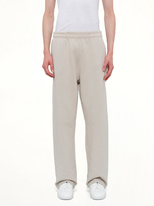 Image of a model wearing Pants. Product name - Straight Leg Sweatpant in White colour by brand - ENTIRE STUDIOS