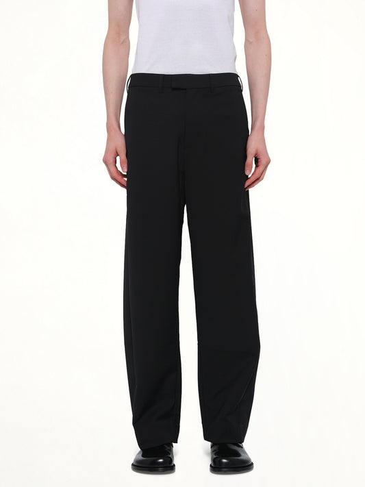 Image of a model wearing Pants. Product name - Lounge Curve Pant in Black colour by brand - ENTIRE STUDIOS