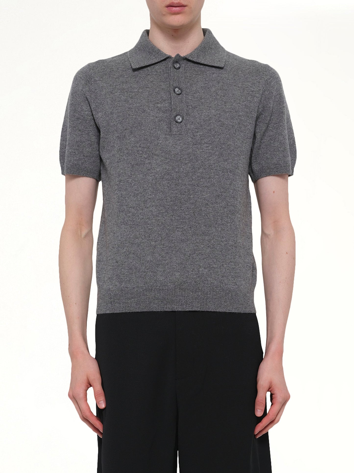Image of a model wearing Shorts. Product name - Short Sleeve Knit Polo in Grey colour by brand - ENTIRE STUDIOS