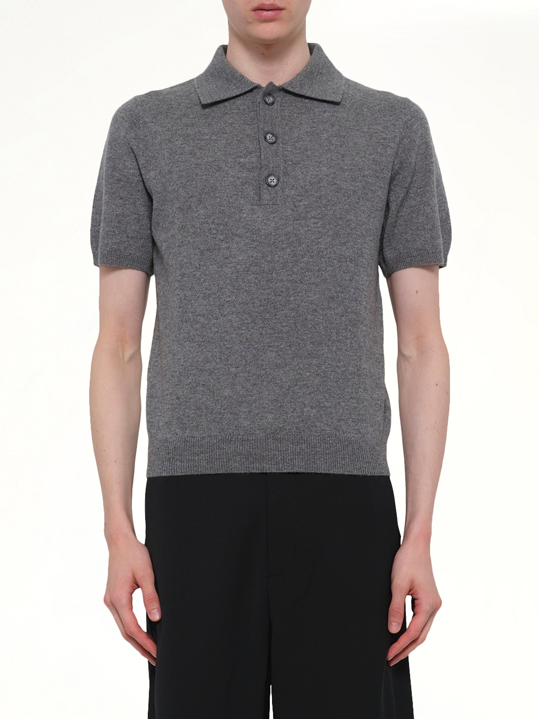 Image of a model wearing Shorts. Product name - Short Sleeve Knit Polo in Grey colour by brand - ENTIRE STUDIOS