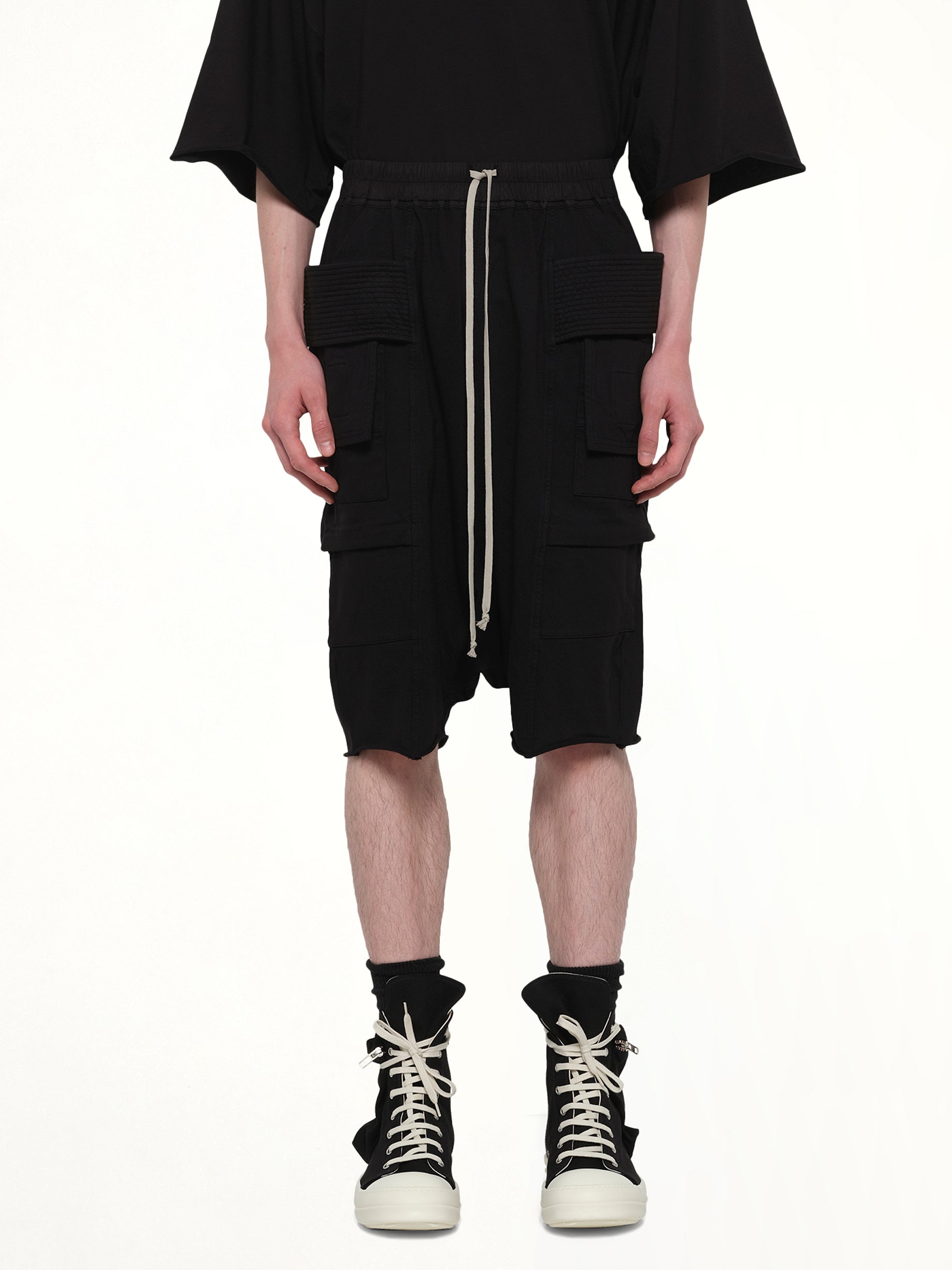 Image of a model wearing Shorts. Product name - Creatch Cargo Pods in Black colour by brand - RICK OWENS DRKSHDW