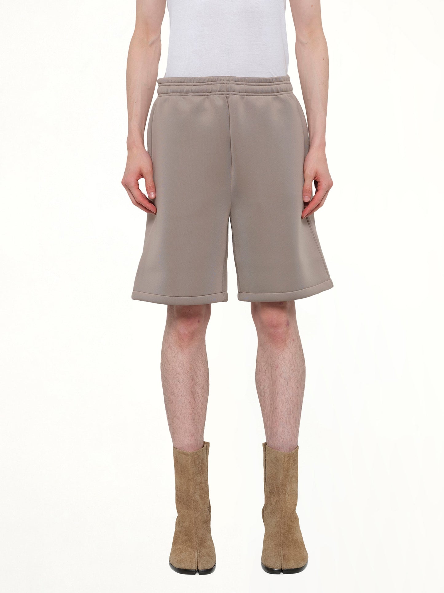 Image of a model wearing Shorts. Product name - Scuba Short in Brown colour by brand - ENTIRE STUDIOS