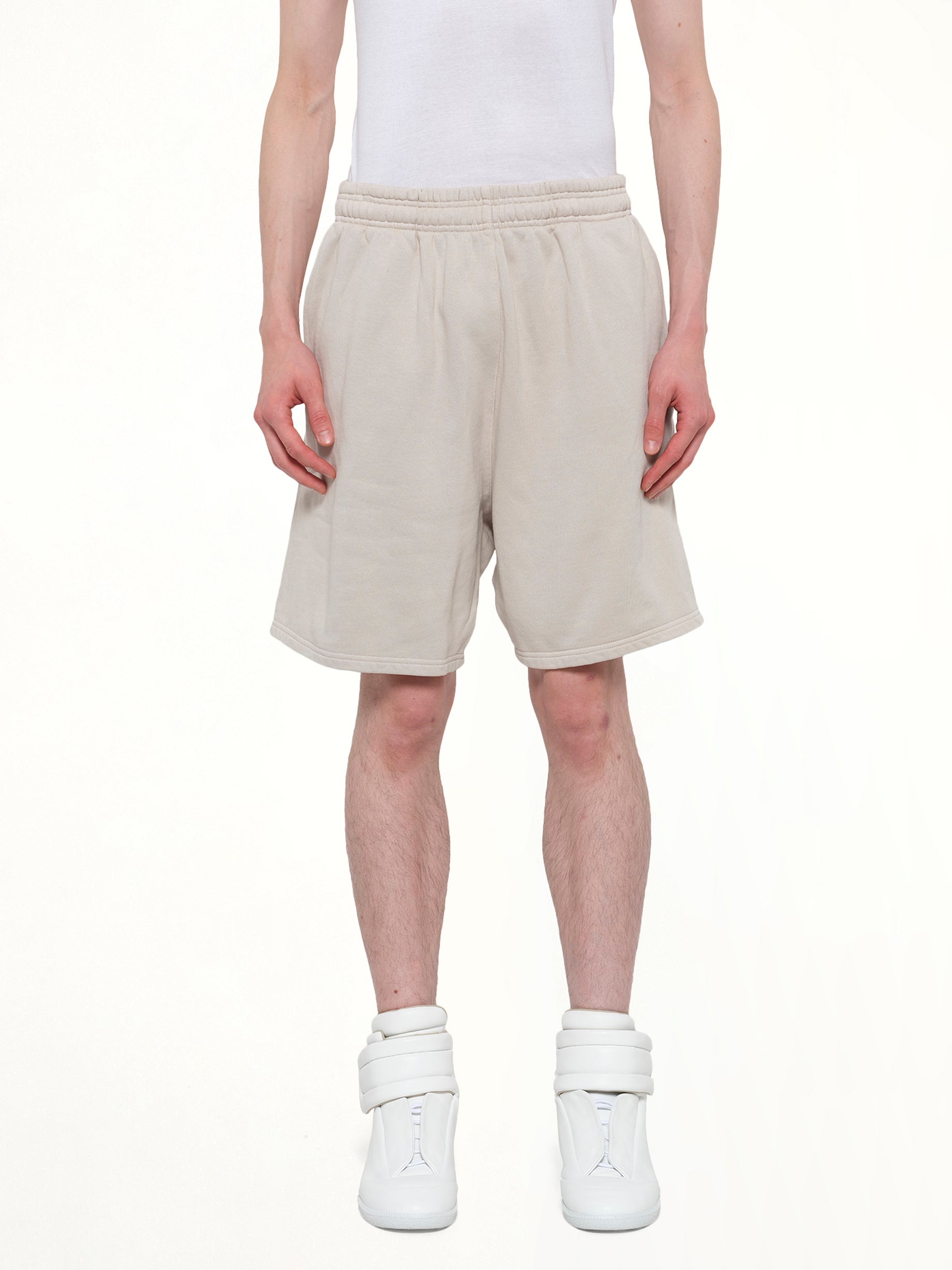 Image of a model wearing Shorts. Product name - Standard Sweatshort in White colour by brand - ENTIRE STUDIOS