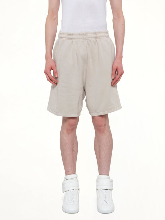 Image of a model wearing Shorts. Product name - Standard Sweatshort in White colour by brand - ENTIRE STUDIOS