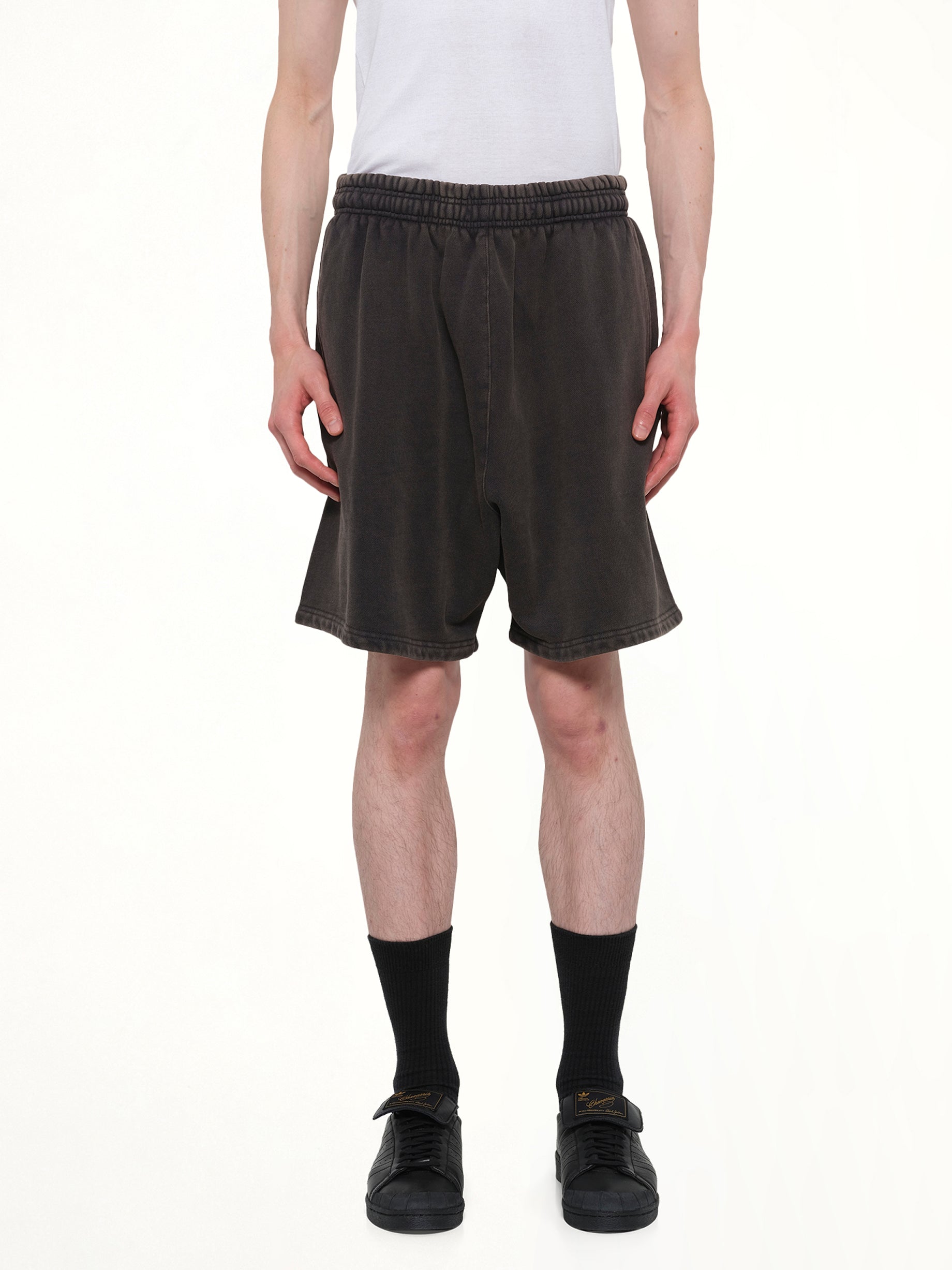 Image of a model wearing Shorts. Product name - Standard Sweatshort in Black colour by brand - ENTIRE STUDIOS
