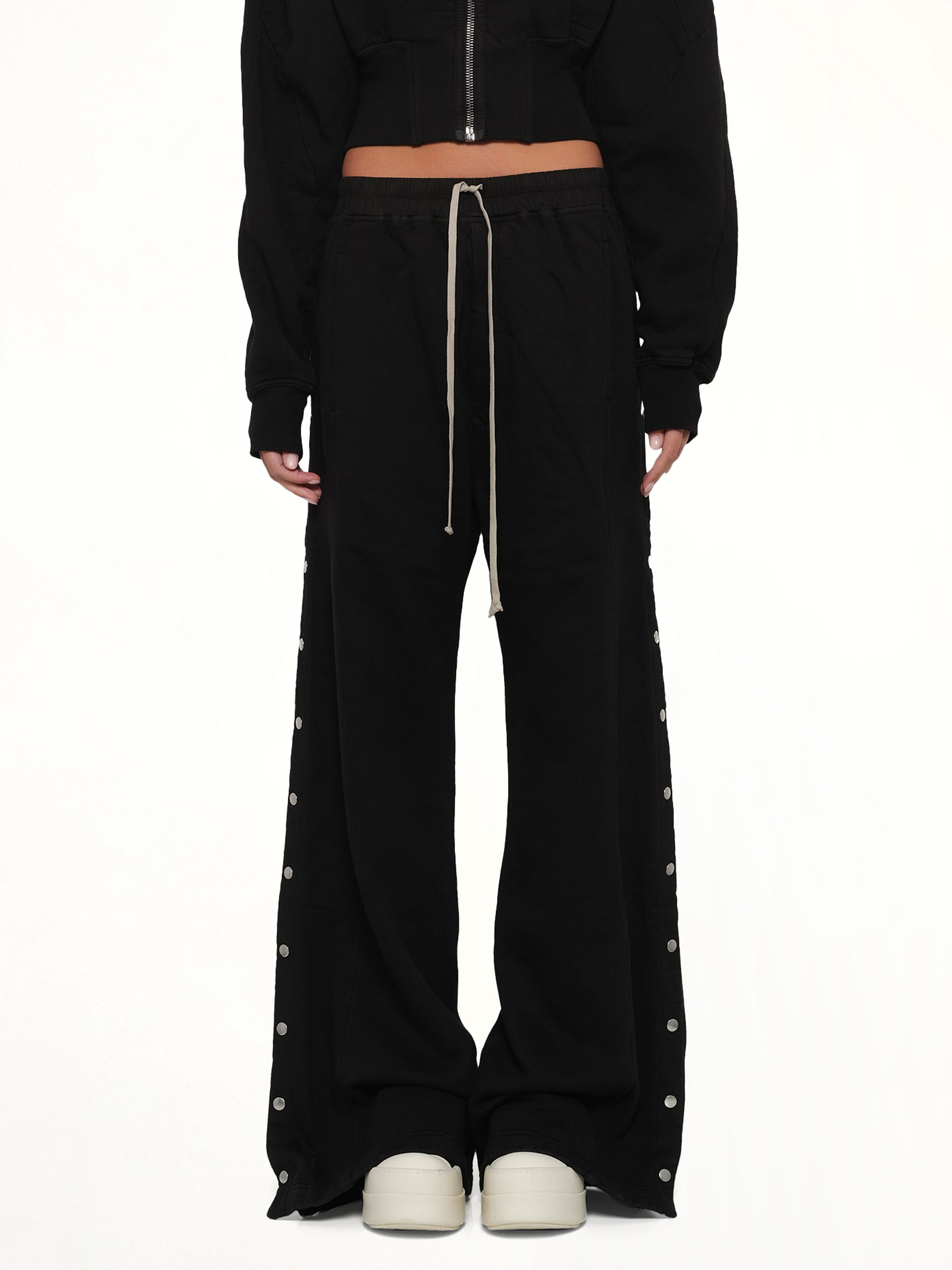 Image of a model wearing Pants. Product name - Wide Pusher Pants in Black colour by brand - RICK OWENS DRKSHDW