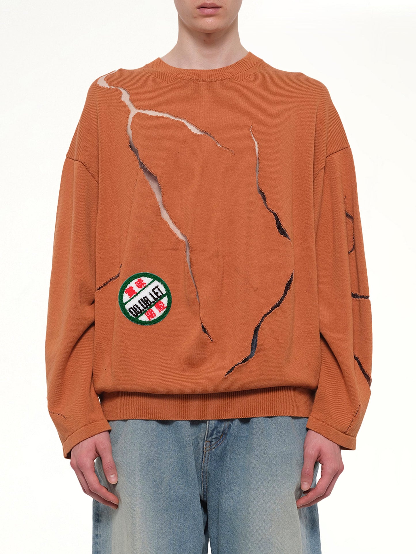 Image of a model wearing Outerwear. Product name - Cracked Egg Knit Pullover in Brown colour by brand - DOUBLET