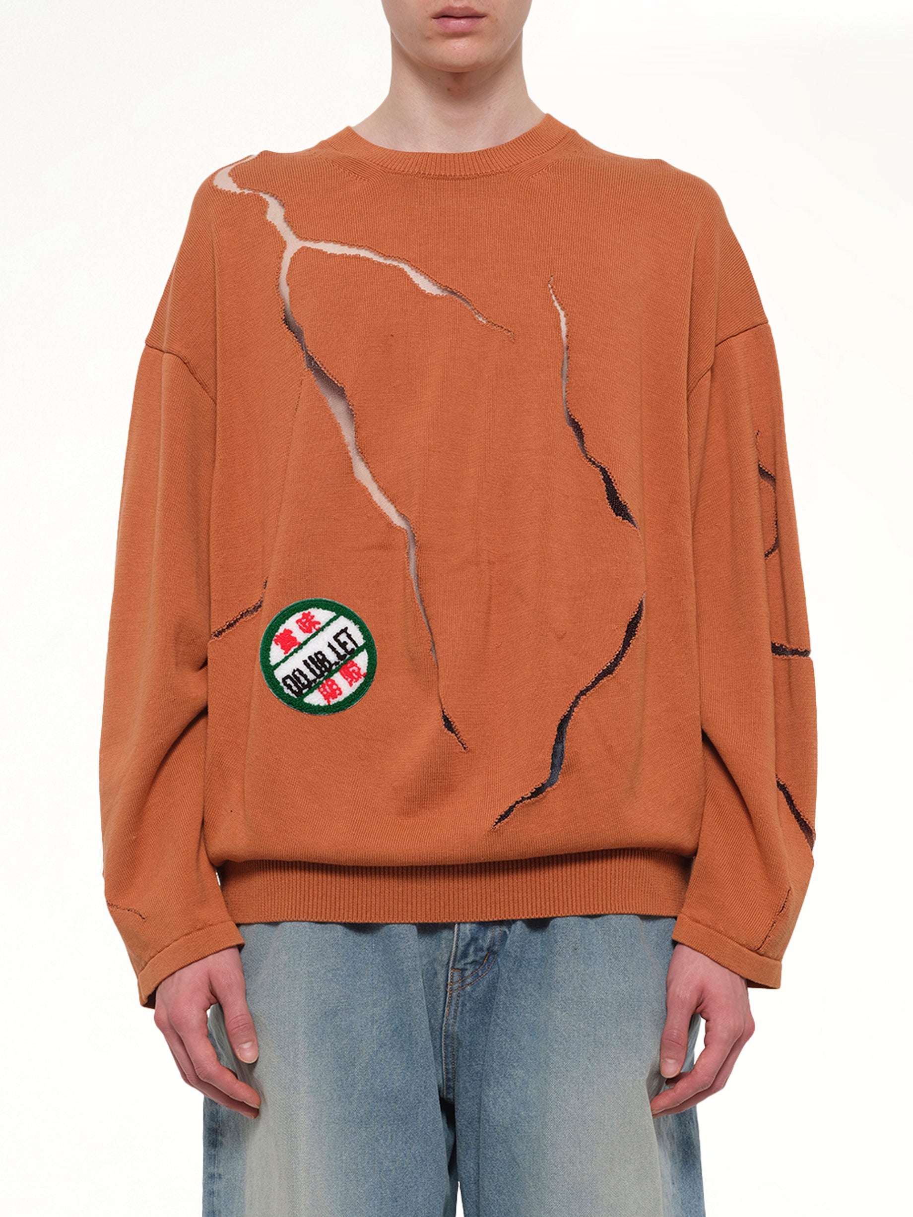 Image of a model wearing Outerwear. Product name - Cracked Egg Knit Pullover in Brown colour by brand - DOUBLET