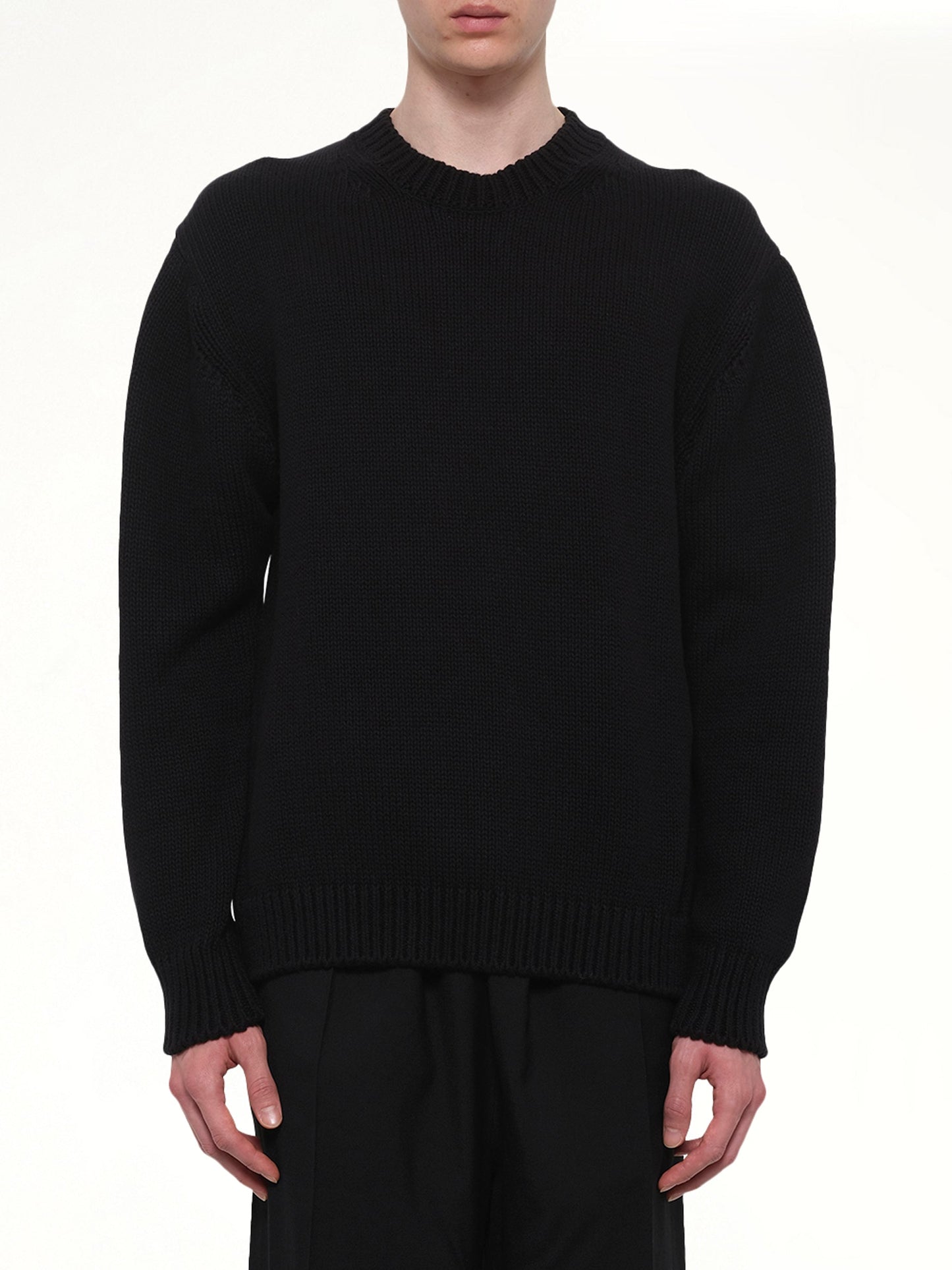Image of a model wearing Outerwear. Product name - Crewneck in Black colour by brand - VOWELS