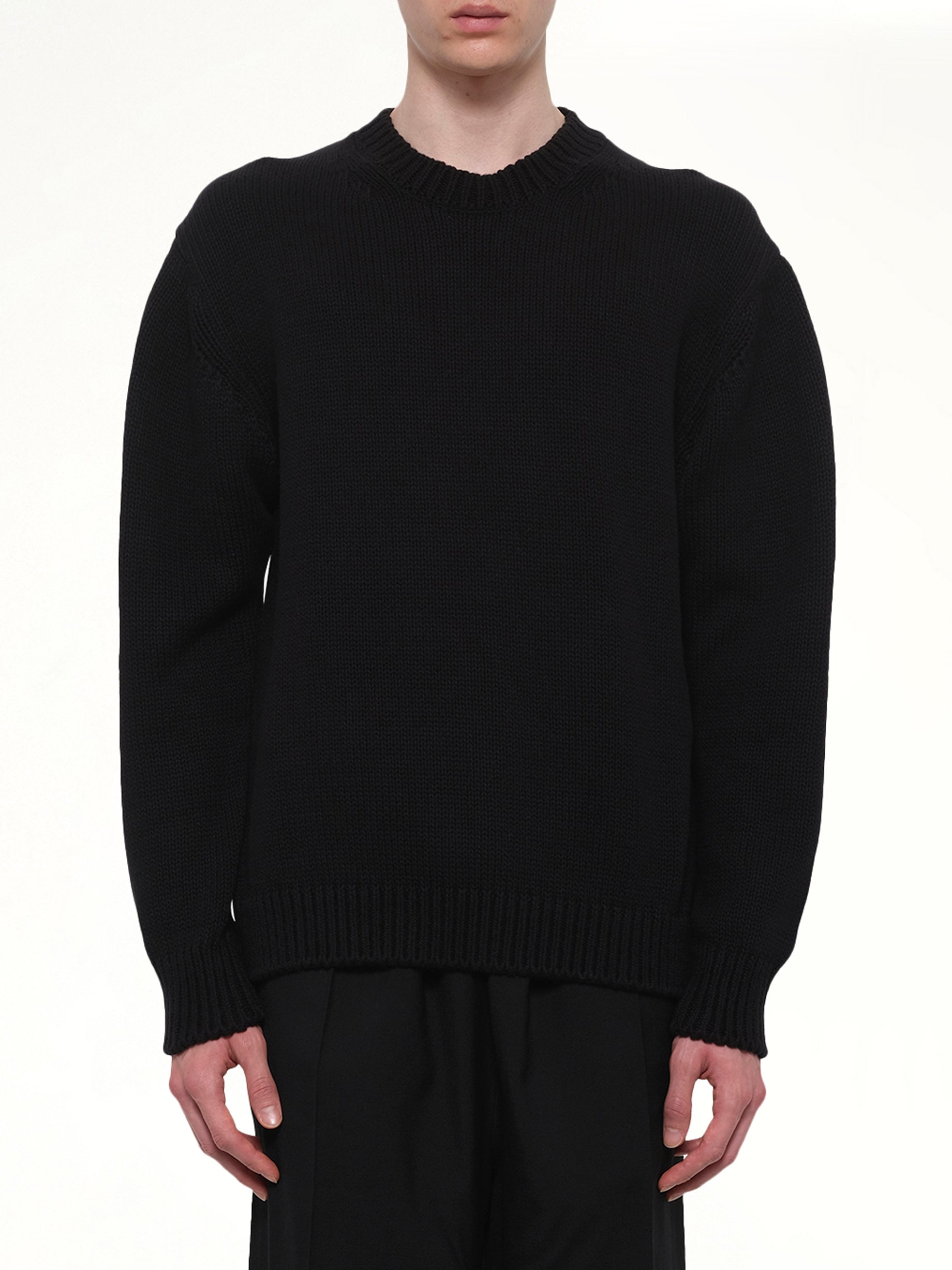 Image of a model wearing Outerwear. Product name - Crewneck in Black colour by brand - VOWELS