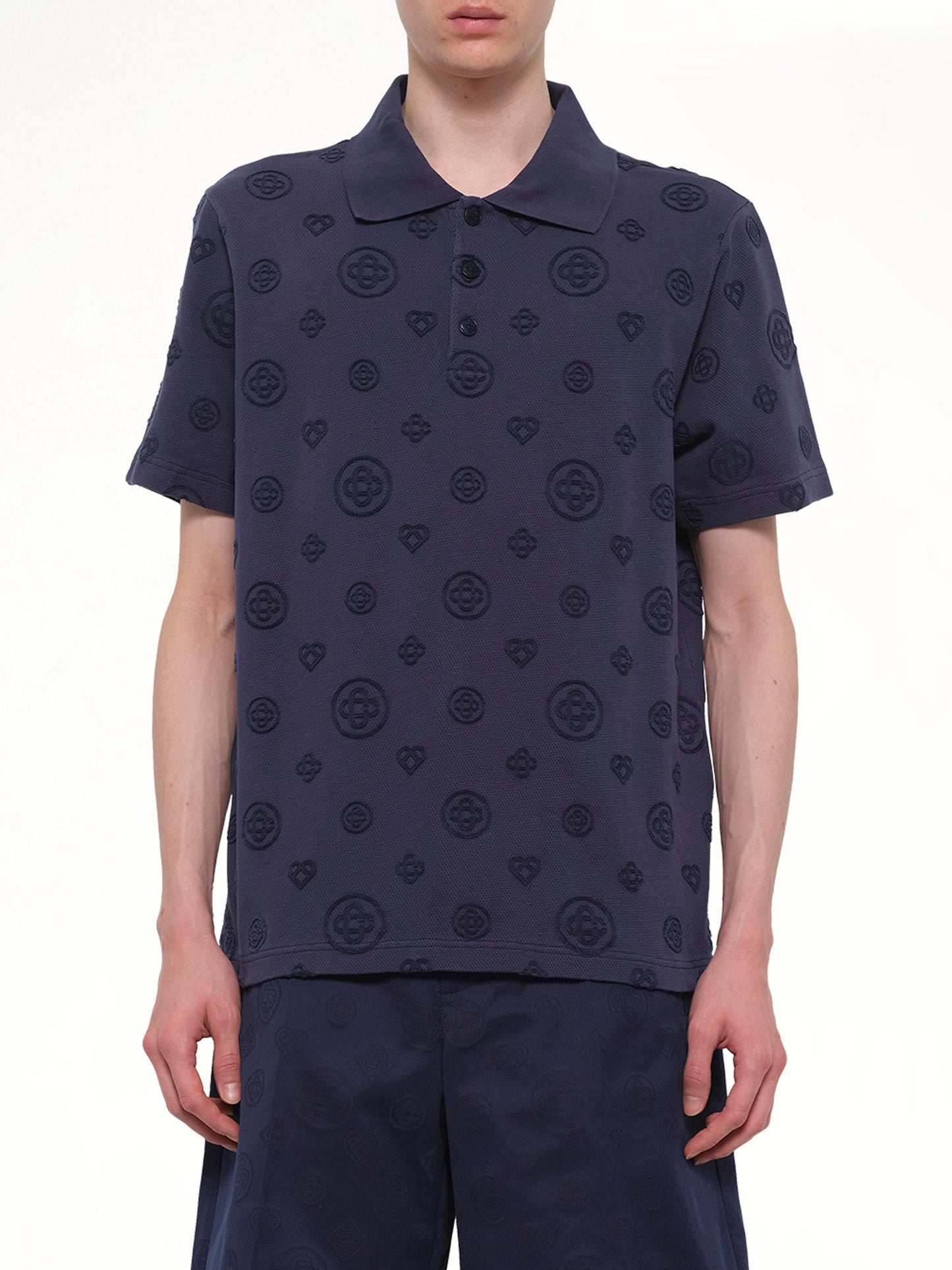 Image of a model wearing Tops. Product name - Applique Monogram Polo in Navy colour by brand - CASABLANCA
