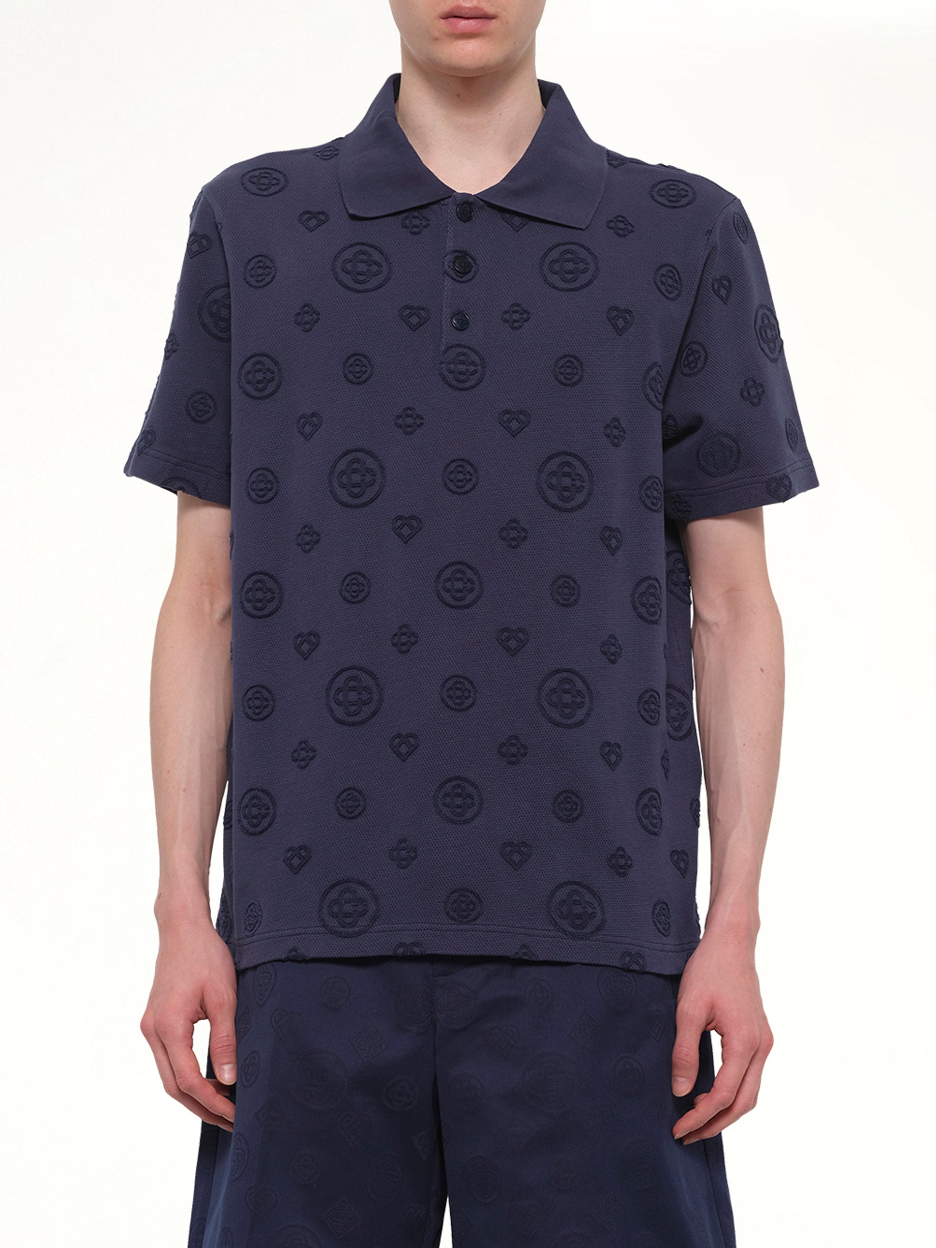 Image of a model wearing Tops. Product name - Applique Monogram Polo in Navy colour by brand - CASABLANCA