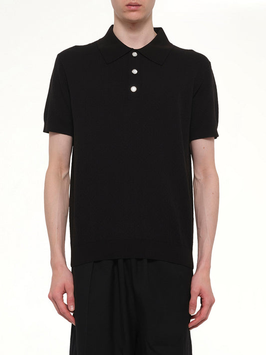 Image of a model wearing Tops. Product name - Pointelle Monogram Polo in Black colour by brand - CASABLANCA